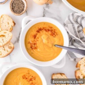 Vegan butternut squash soup in a white crock style bowl.