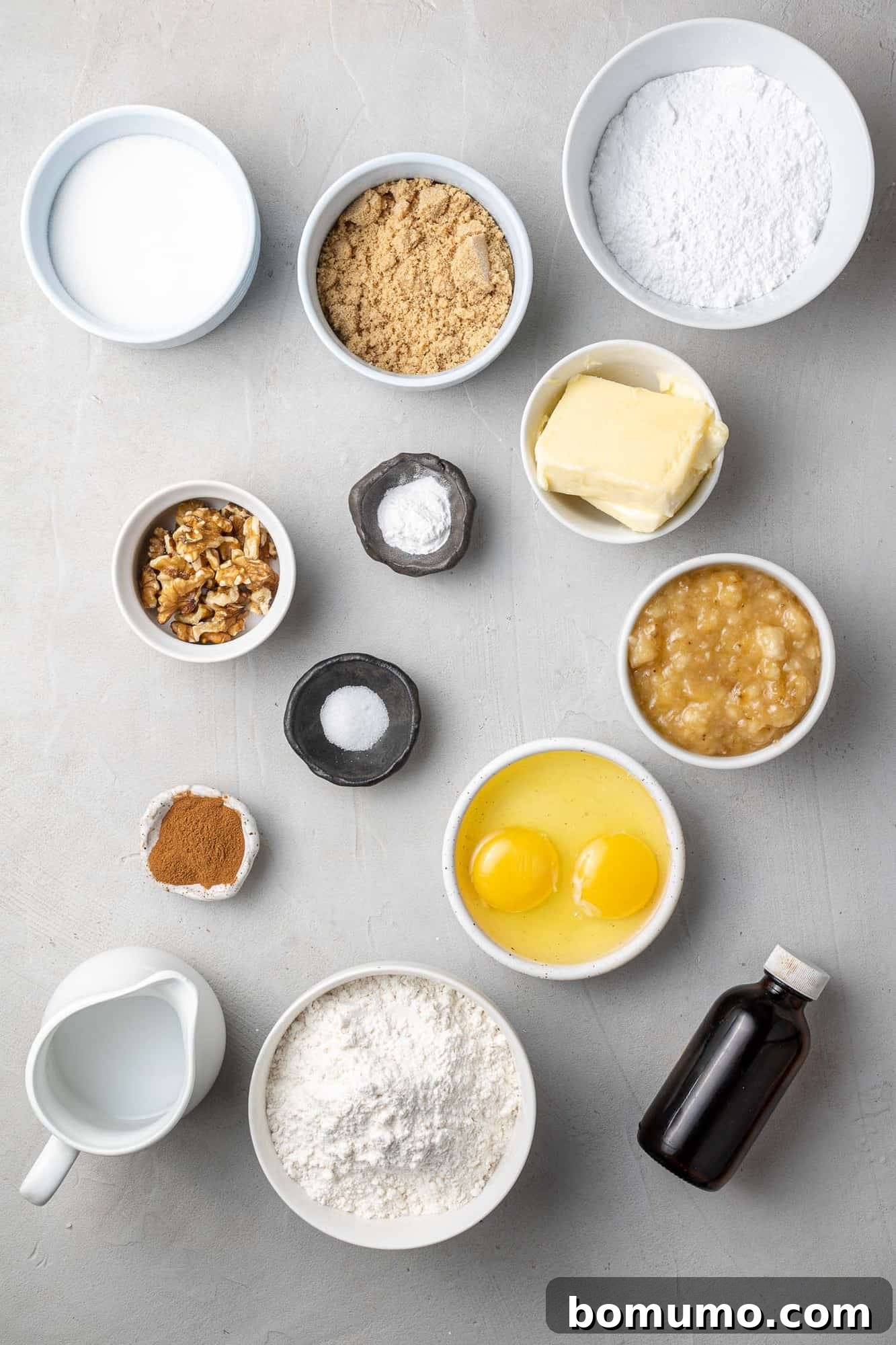 Overhead shot of all the ingredients needed to make the baked banana donuts, perfectly arranged.