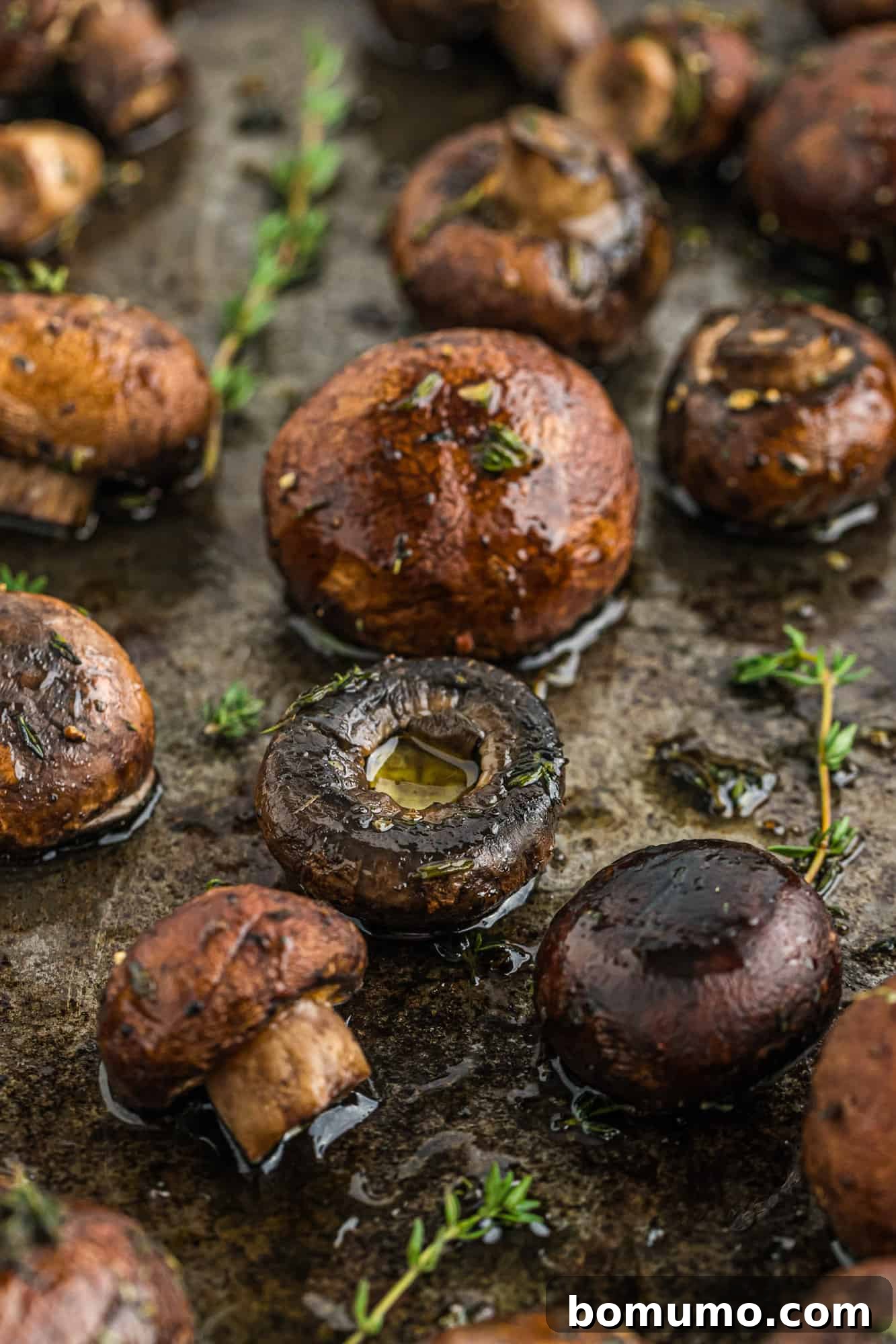 Umami Roasted Mushrooms 9 A sheet pan filled with perfectly roasted mushrooms, golden brown and tender, with slightly crispy edges, after being removed from the oven.