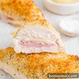 Baked chicken cordon bleu, cut in half to show filling.
