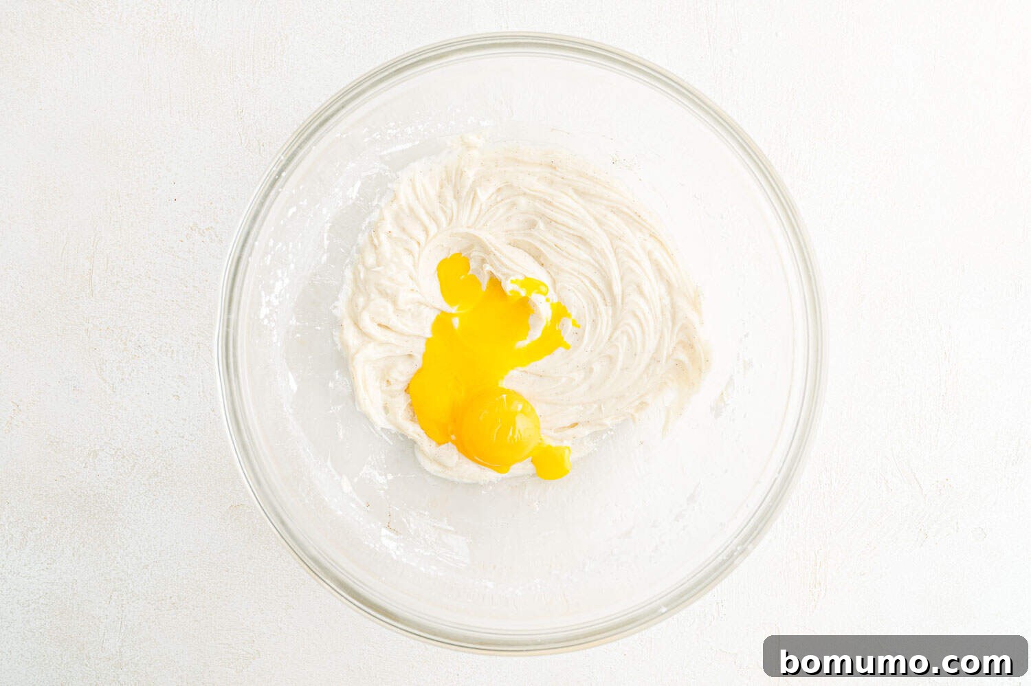 Egg yolks added to the creamed butter and sugar mixture, ready for further mixing.
