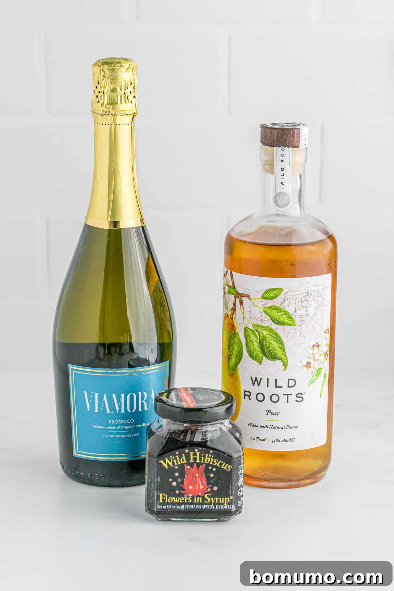 Ingredients needed: prosecco, pear vodka, hibiscus flowers, neatly arranged.