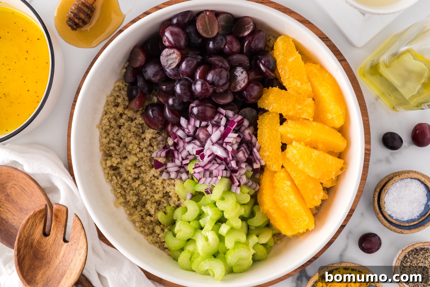 Unmixed ingredients for the quinoa salad in a large bowl, showcasing the fresh components before combining.