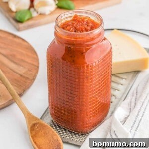 Homemade pizza sauce in a glass jar, ready to use for delicious pizzas.