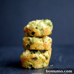 Stack of three muffins on dark gray surface.
