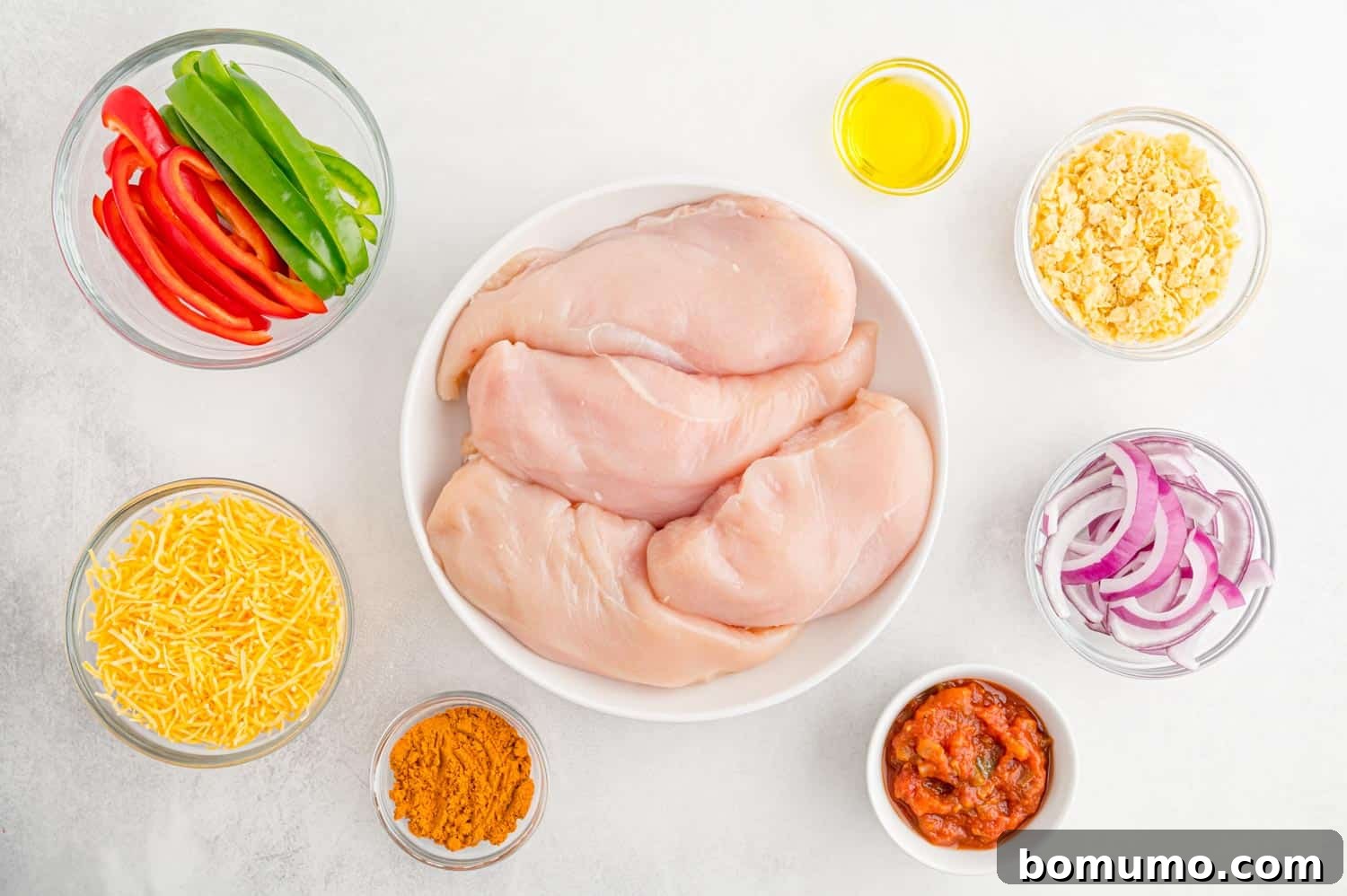 Overhead view of all ingredients needed for preparing Fajita Stuffed Chicken, neatly arranged.