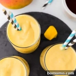 Overhead view of three mango smoothies.