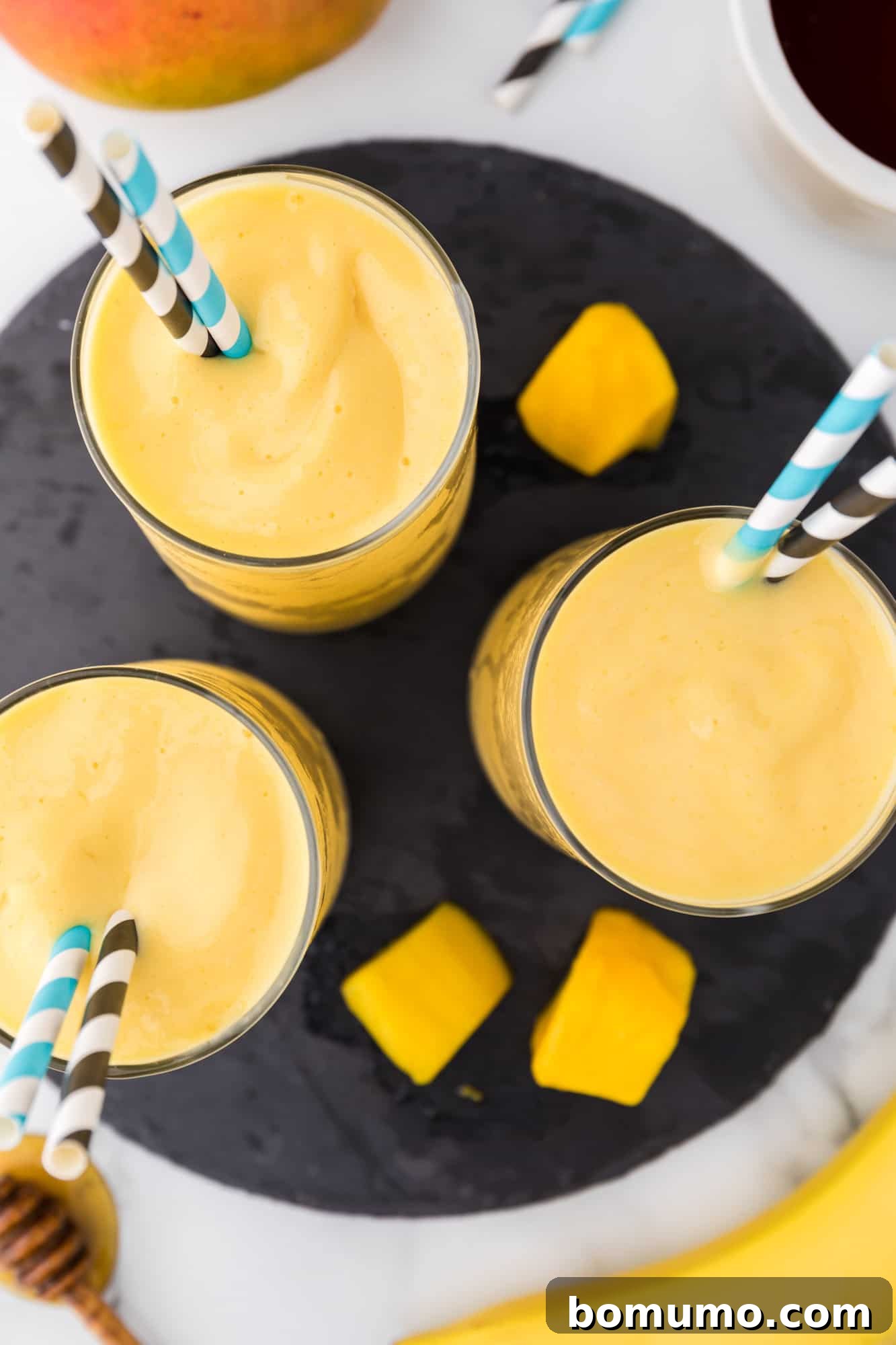 Overhead view of mango smoothies.