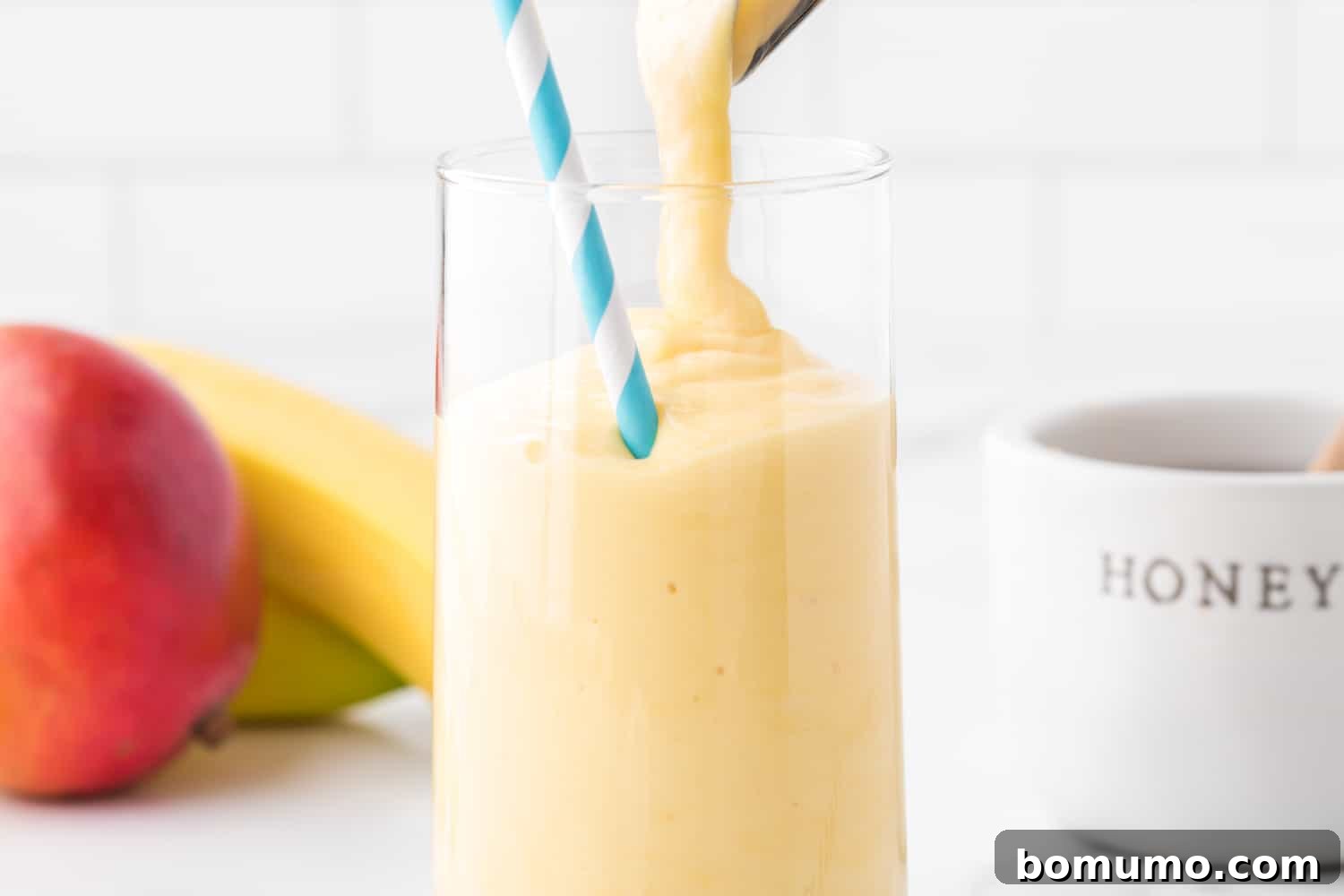Smoothie being poured into a glass.