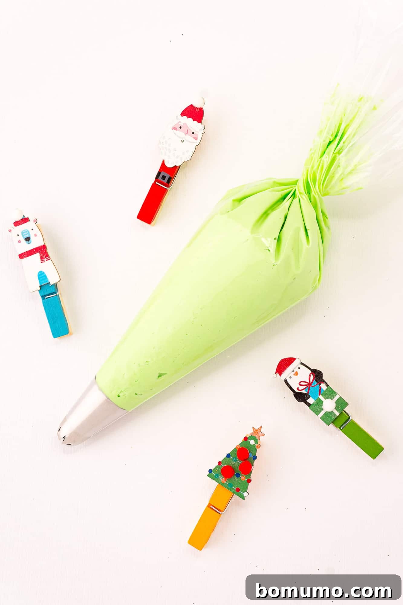 Vibrantly green vanilla buttercream frosting, perfectly prepared and loaded into a piping bag, ready for decorating.