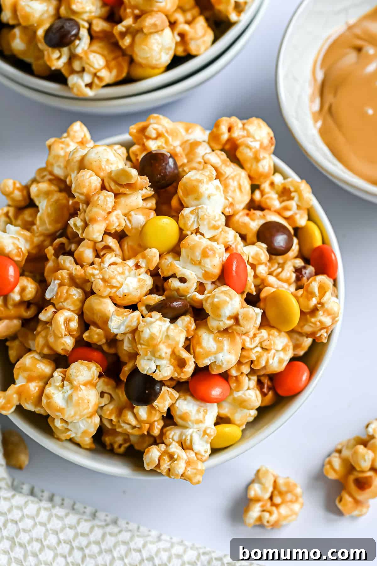 Peanut butter popcorn mixed with colorful Reese's Pieces candies.