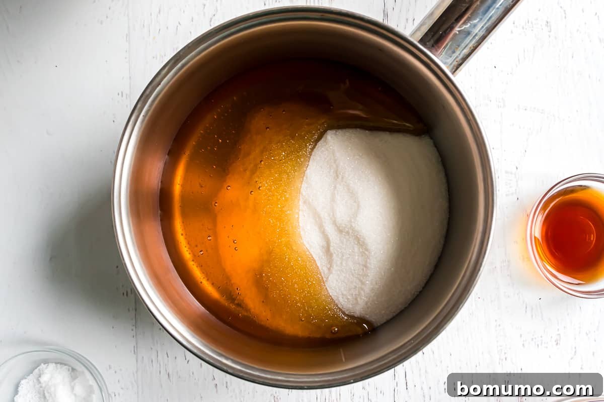 Granulated sugar and honey combined in a saucepan, before heating.