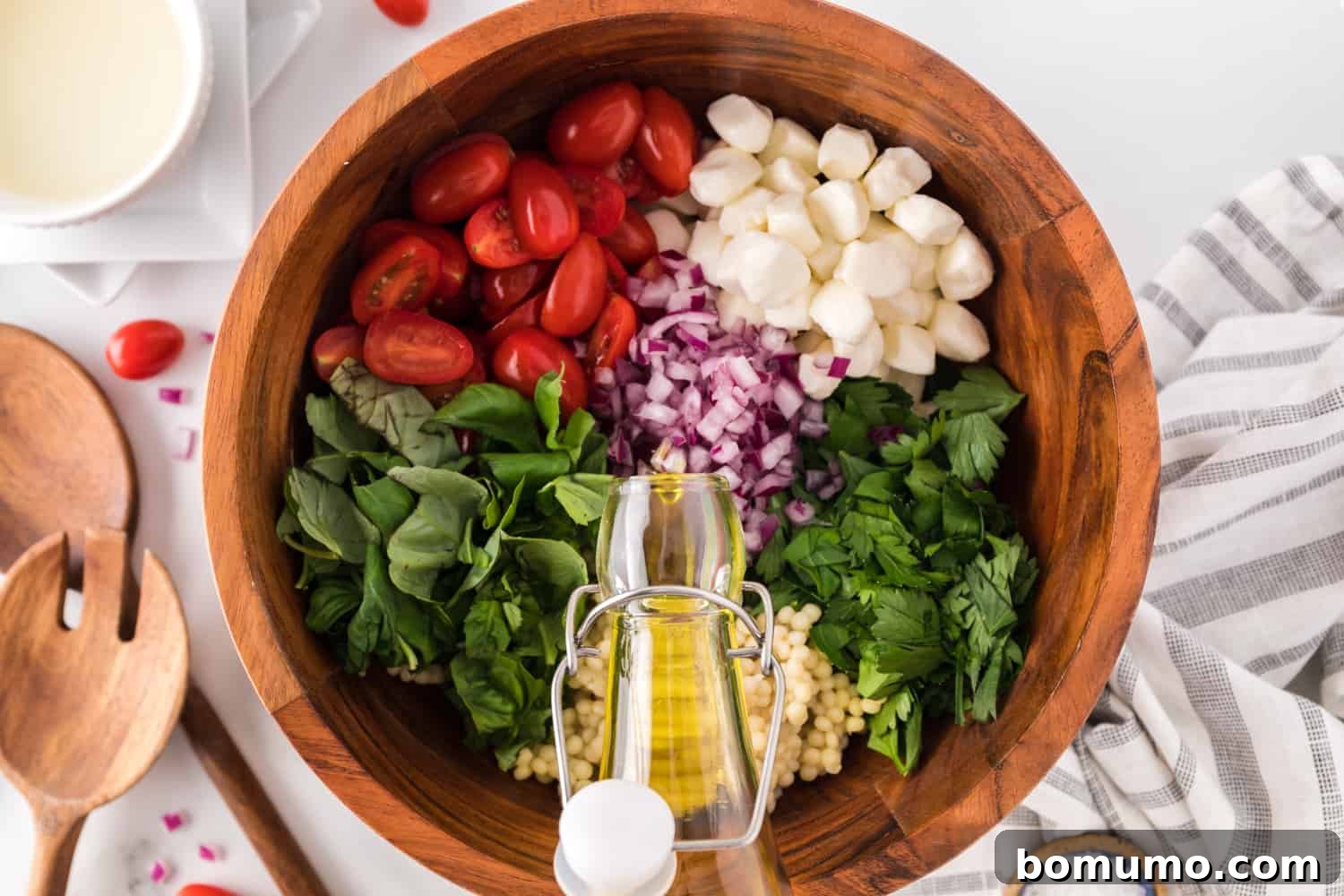 Dressing being added to salad.