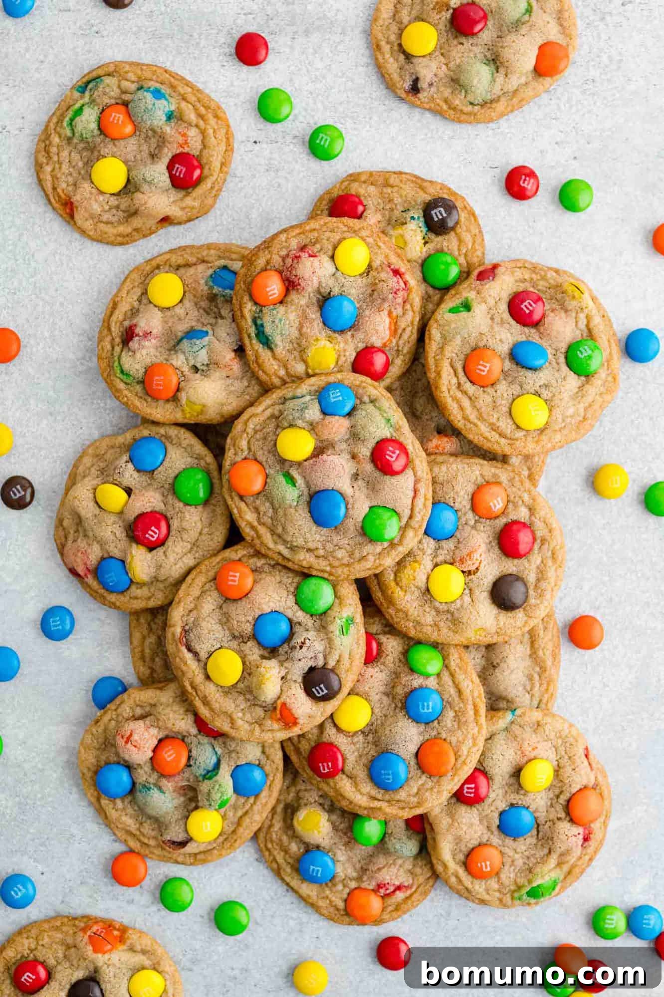 Ultimate M M Cookies 13 A generous pile of freshly baked M&M cookies, showcasing their colorful candies and inviting texture.