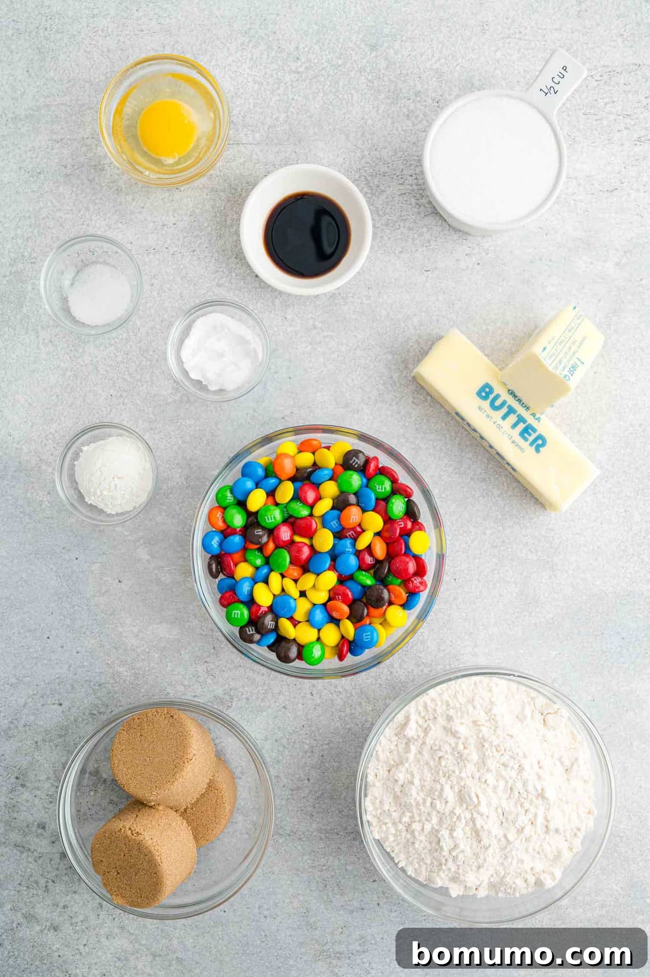 Ultimate M M Cookies 4 Individual bowls neatly arranged, showcasing all the measured ingredients ready for making M&M cookies.
