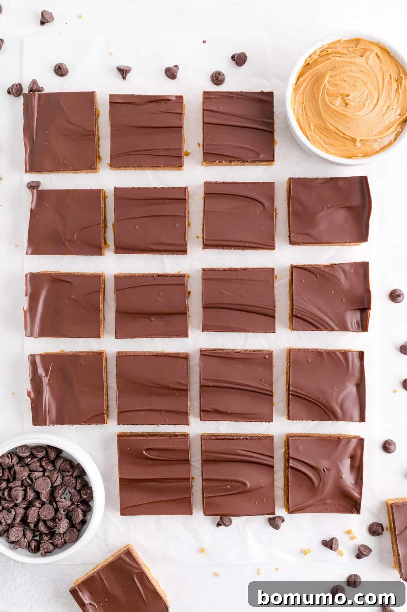 Array of no-bake peanut butter bars neatly arranged on a serving plate.