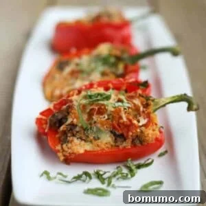 Image of quinoa stuffed bell peppers with pepperoni, mushrooms, cheese, and pizza sauce.