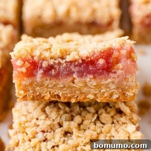 Rhubarb bars, with crumb topping, stacked on each other.