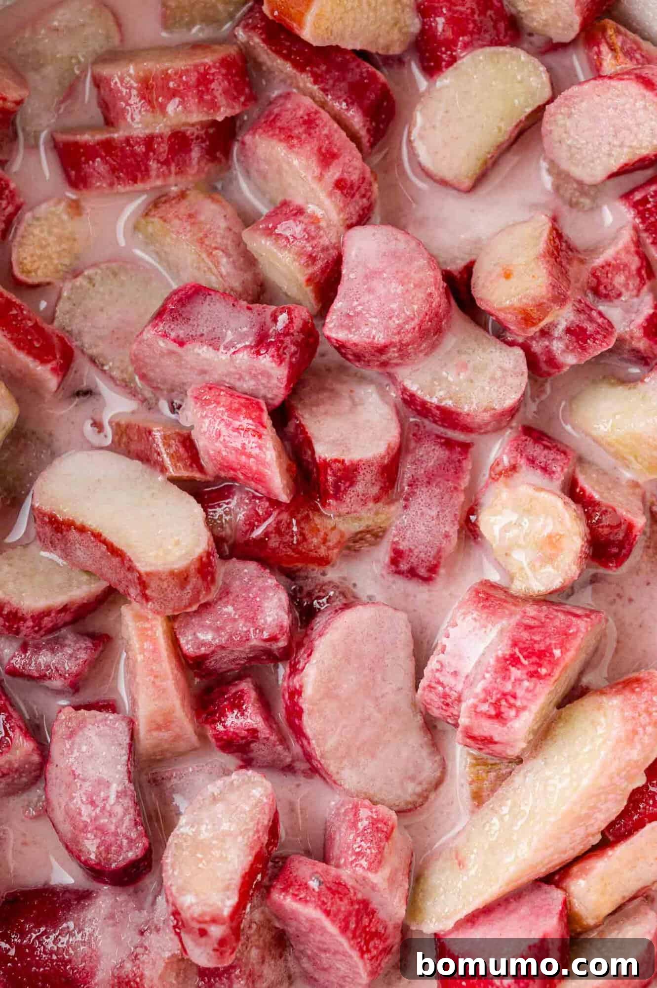 Uncooked rhubarb filling ingredients mixed in a saucepan.