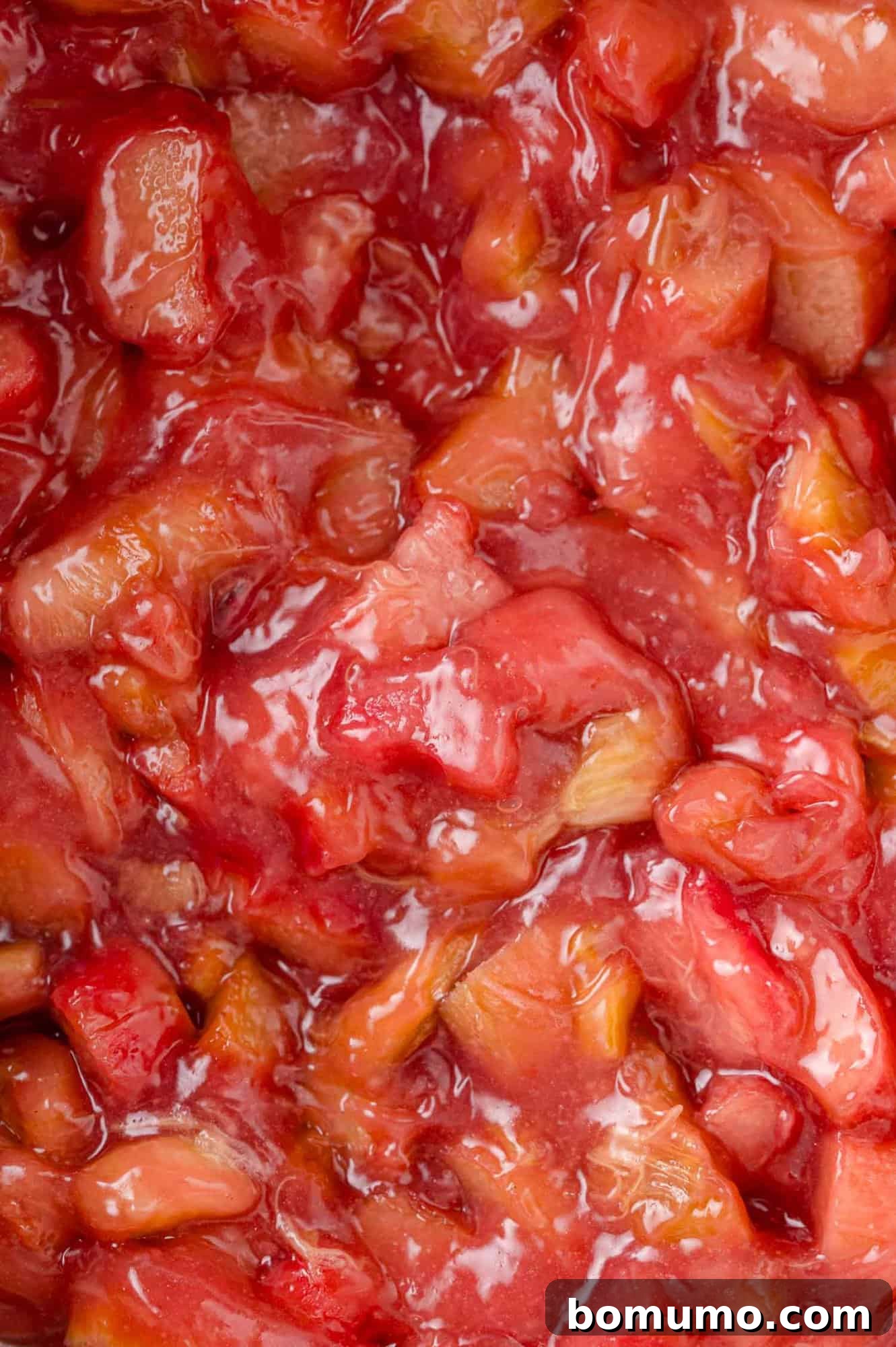 Cooked rhubarb filling, thickened to a jammy consistency in a saucepan.