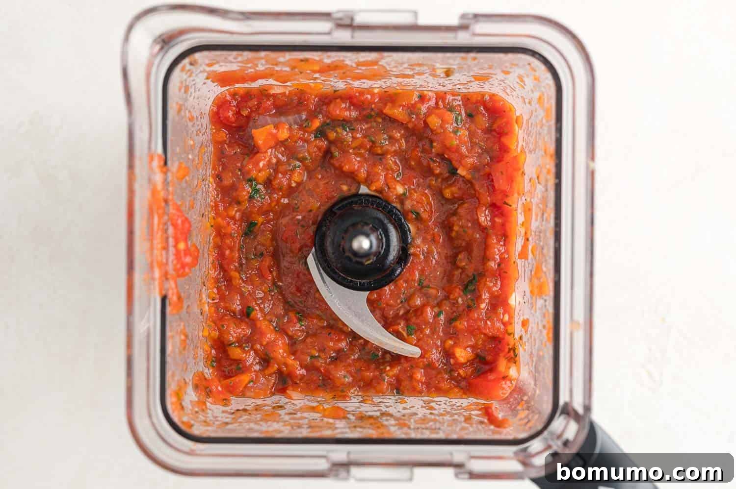Blended vegetables and tomatoes in a blender.