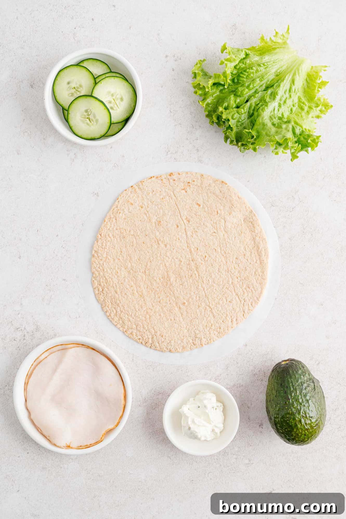 A vibrant and appealing display of fresh ingredients meticulously laid out, poised for assembly into the best turkey wraps. The colors and textures promise a delicious culinary creation.