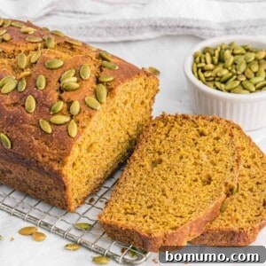 Healthy pumpkin bread, partially sliced, showing its tender crumb.