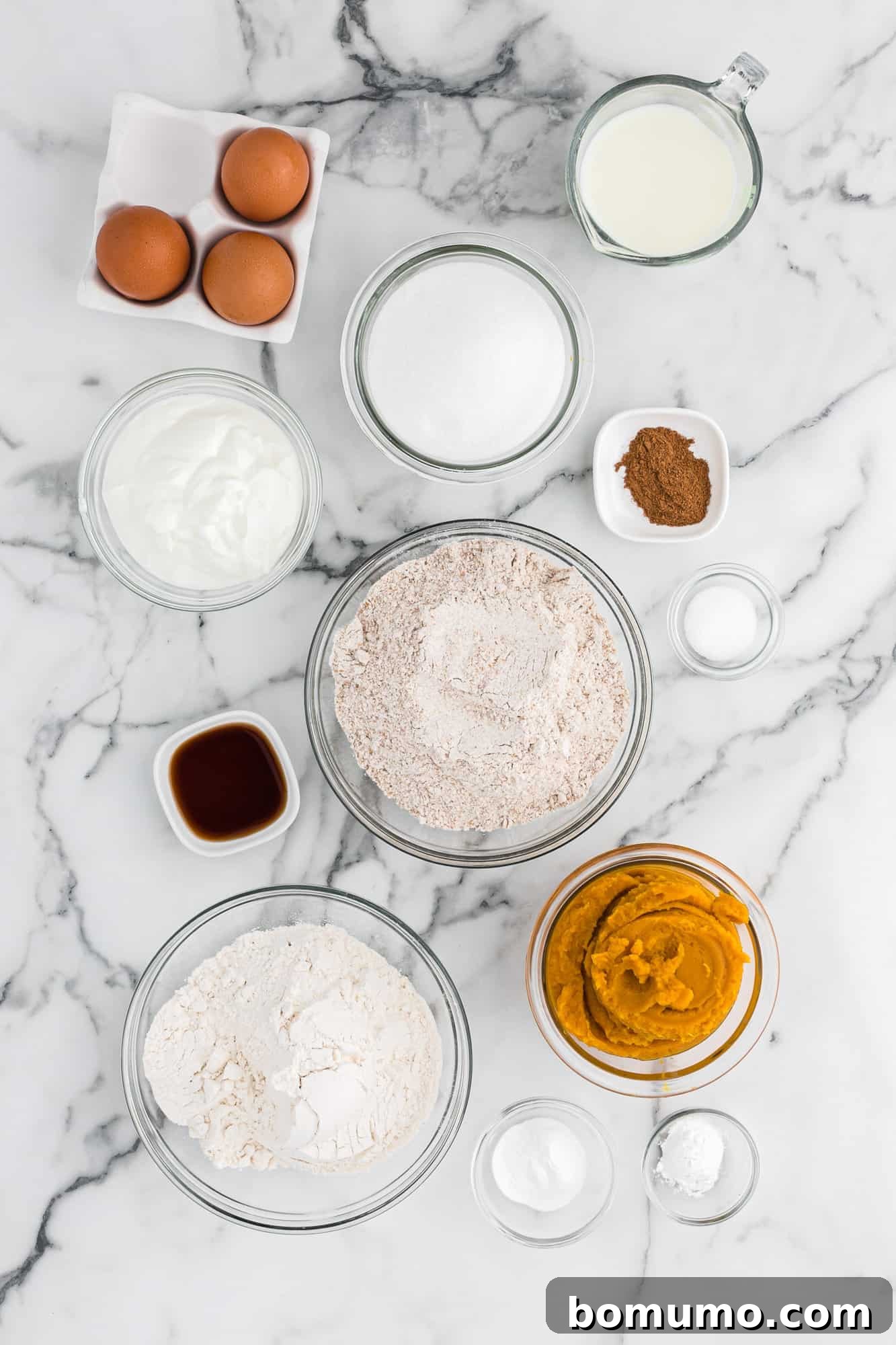 A vibrant selection of ingredients, including a can of pumpkin purée, essential for making delicious healthy pumpkin bread.