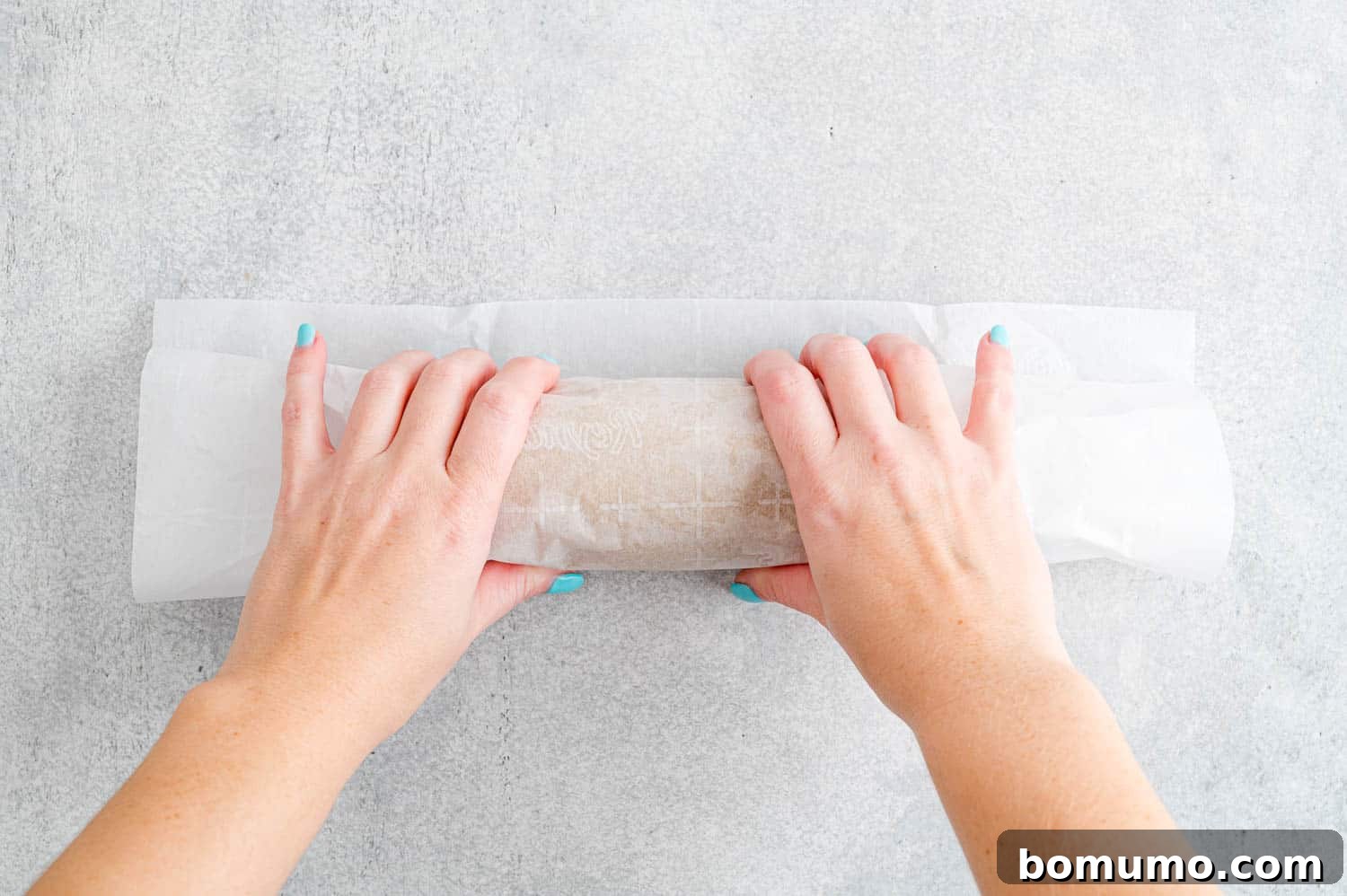 Dough rolled into a log and wrapped in parchment.