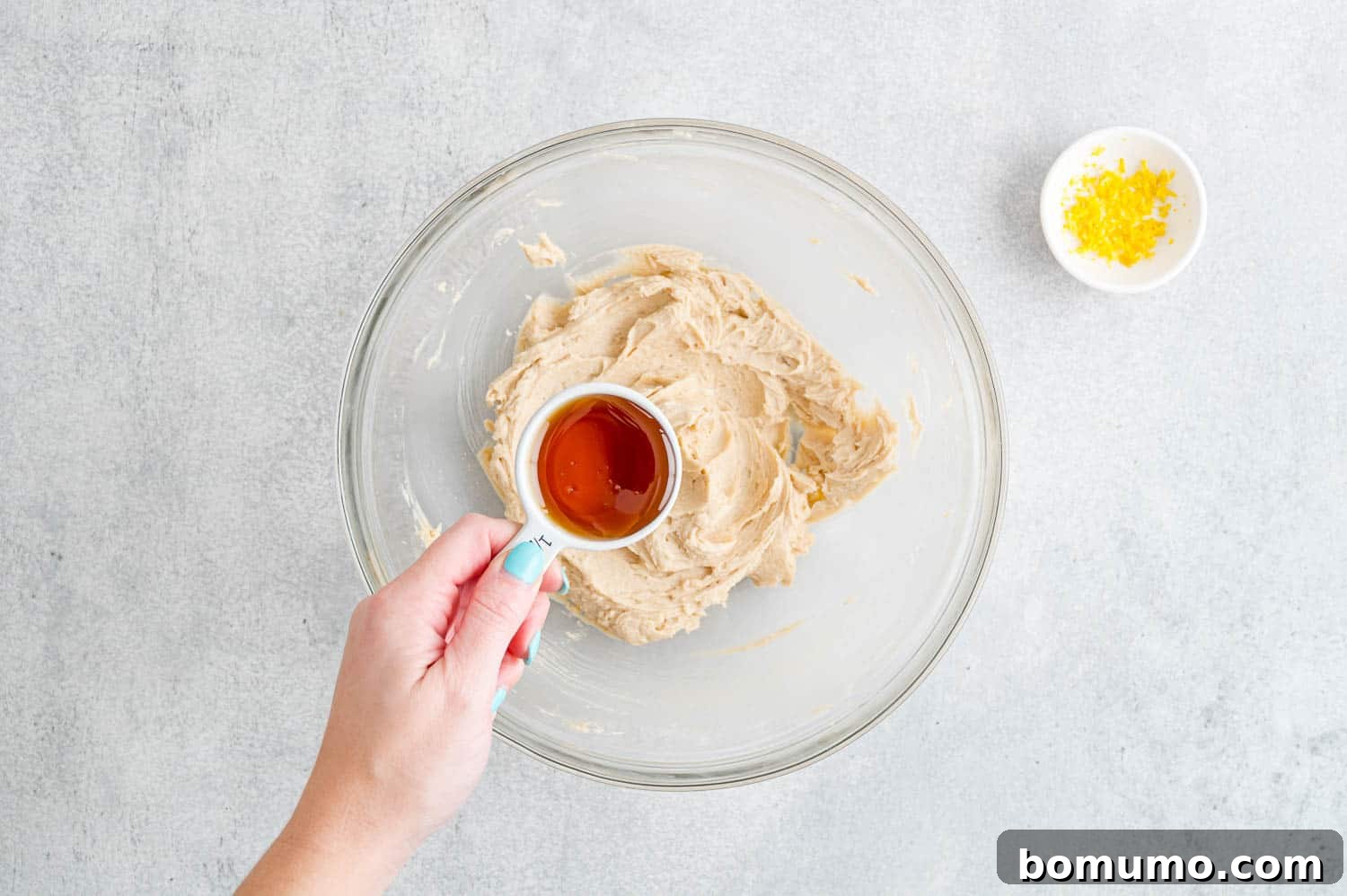 Honey being added to bowl.