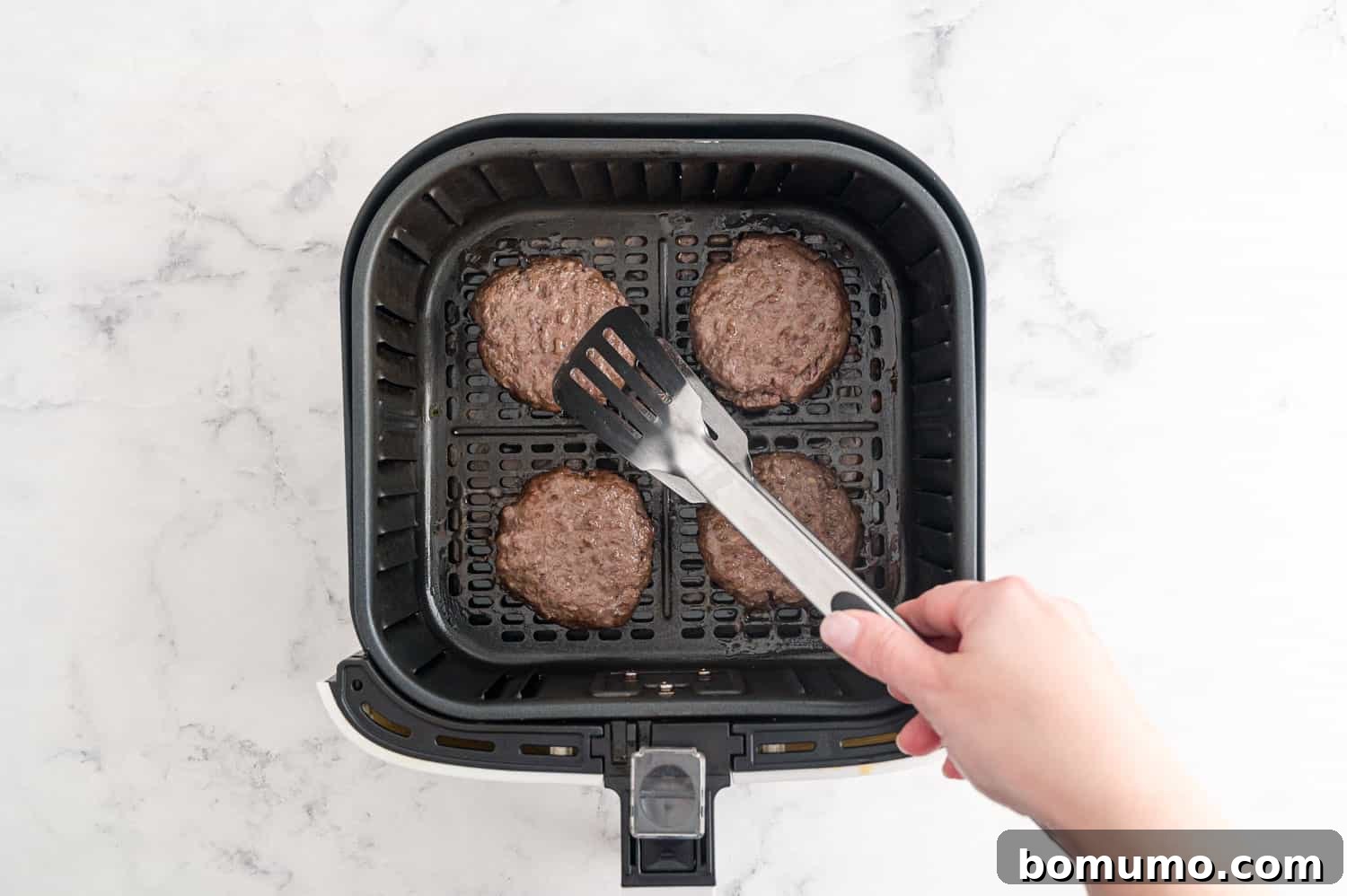 Burgers being flipped.