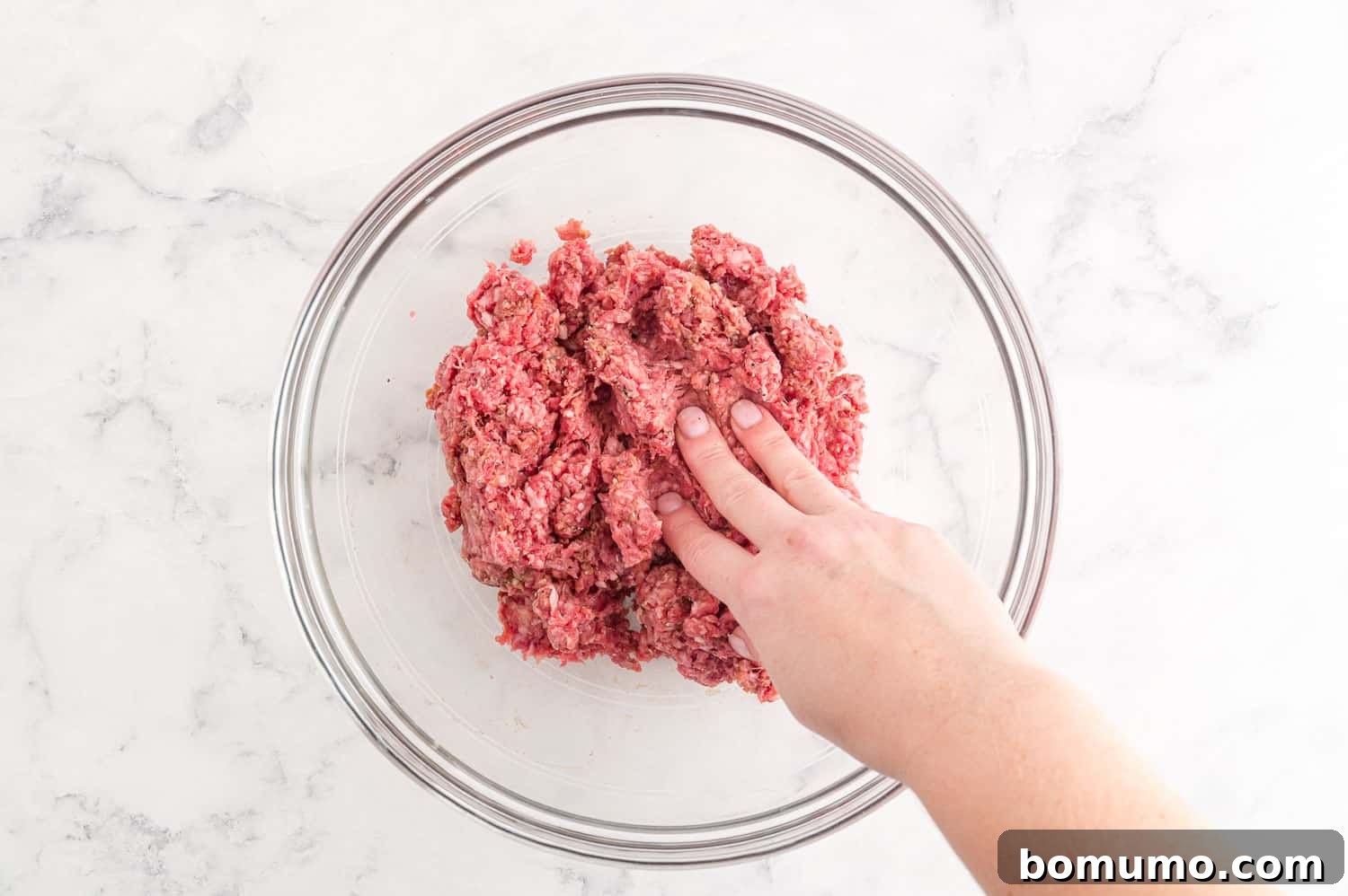 Ingredients being mixed by hand.