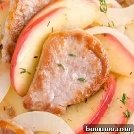 Pork tenderloin and apples garnished with thyme.