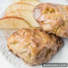 Close up of two air fryer apple fritters with a glaze.