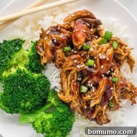 Delicious Crockpot Teriyaki Chicken served over fluffy rice with steamed broccoli.
