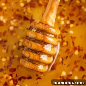 Close up of hot honey with a honey dipper, ready to be served.