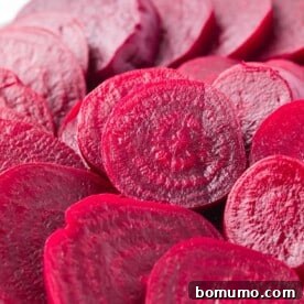 Sliced boiled beets, vibrant and tender, perfect for salads and various dishes.