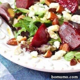 A vibrant salad featuring tender beets, crumbled feta, and roasted almonds, drizzled with a delicious dressing.