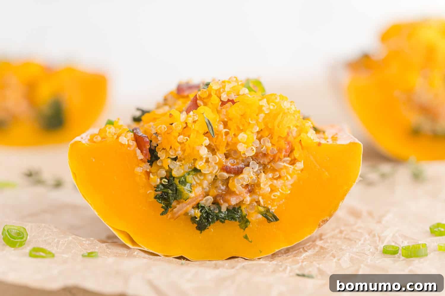 Close up view of slice of stuffed butternut squash.