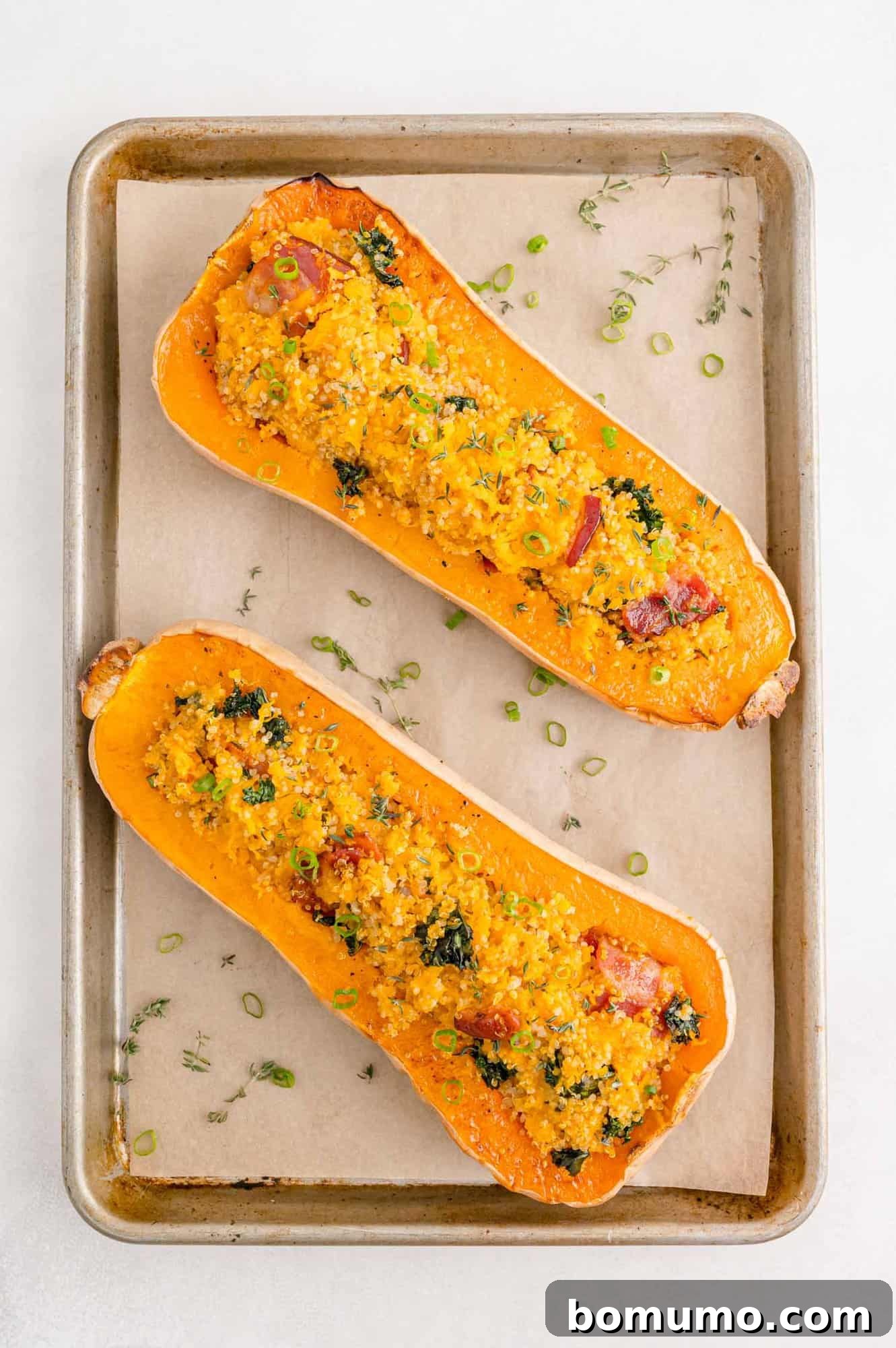 Overhead view of two stuffed butternut squash halves.