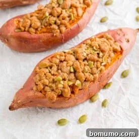 Twice baked sweet potatoes with a crunchy streusel topping, presented on a rustic board.