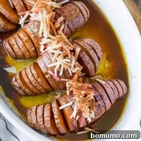 Beautifully fanned Hasselback sweet potatoes in a white baking dish, roasted to perfection.