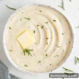 Ultra-creamy white parsnip puree, beautifully garnished with fresh rosemary sprigs.