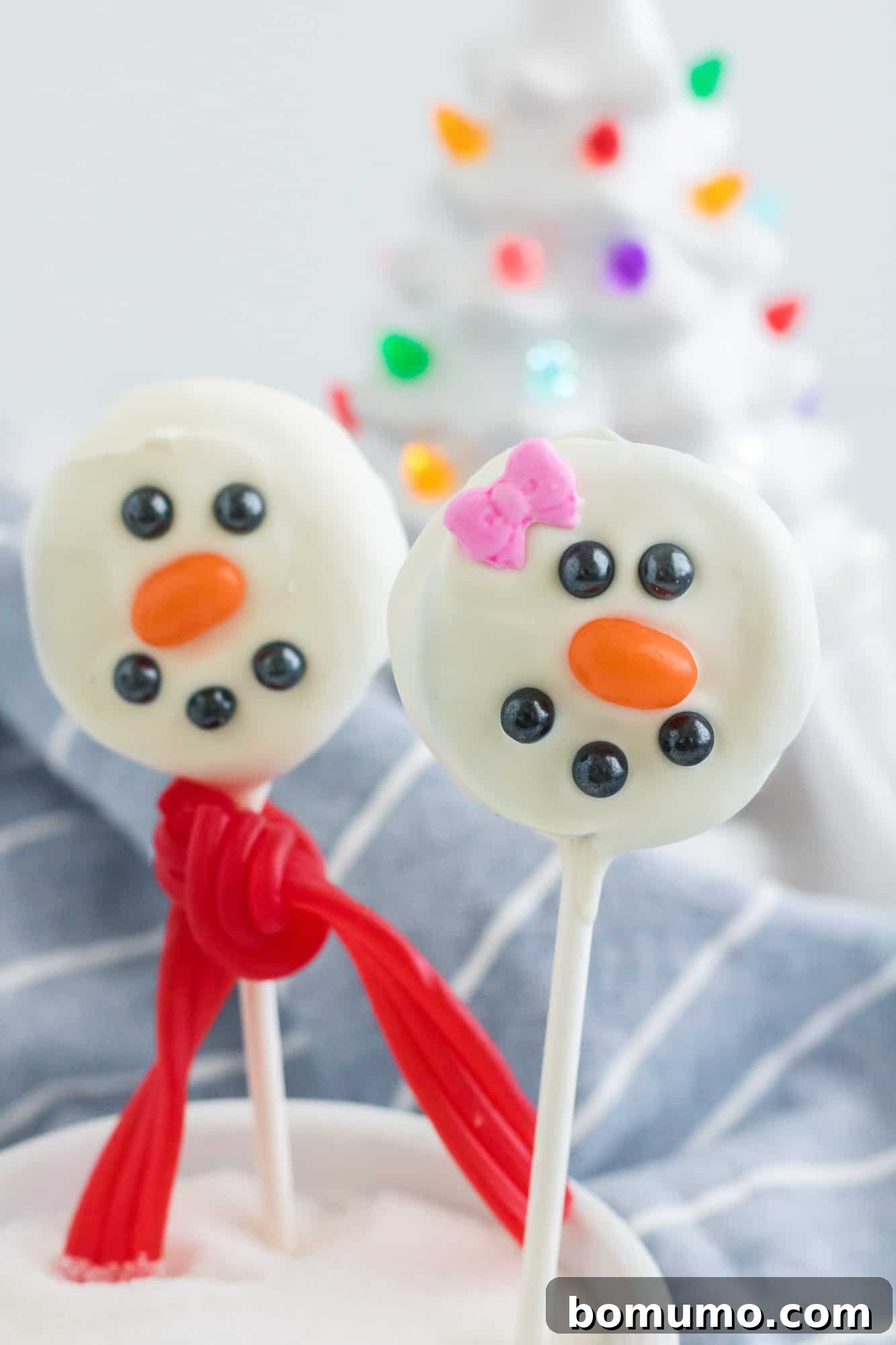 Oreos on sticks, decorated like snowmen.