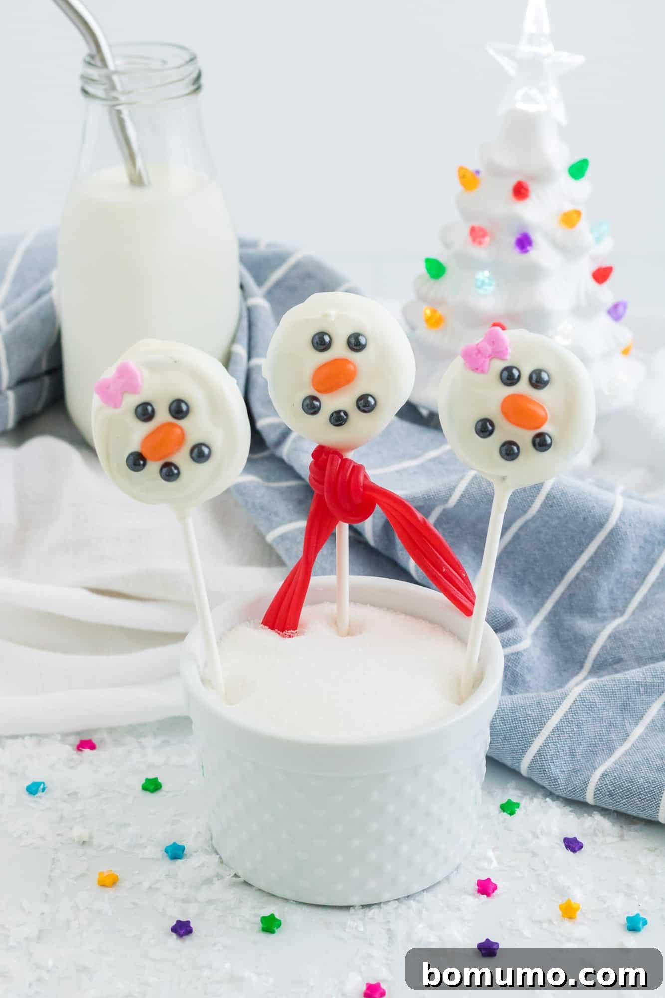 Snowmen pops in a cup of sugar.