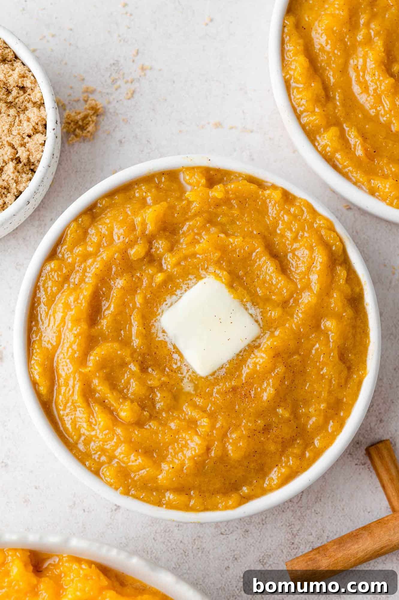 Butter melting on a bowl of squash mash.