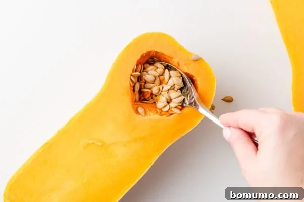 Seeds being scooped out of squash.