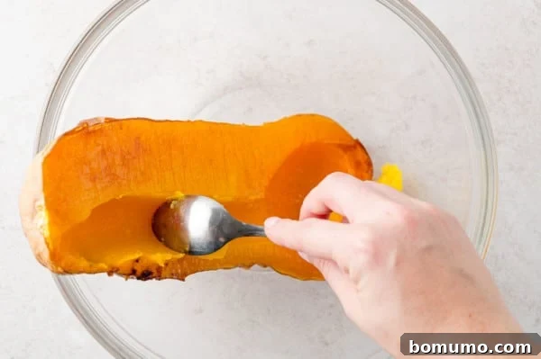 Squash being scooped out of the peel.