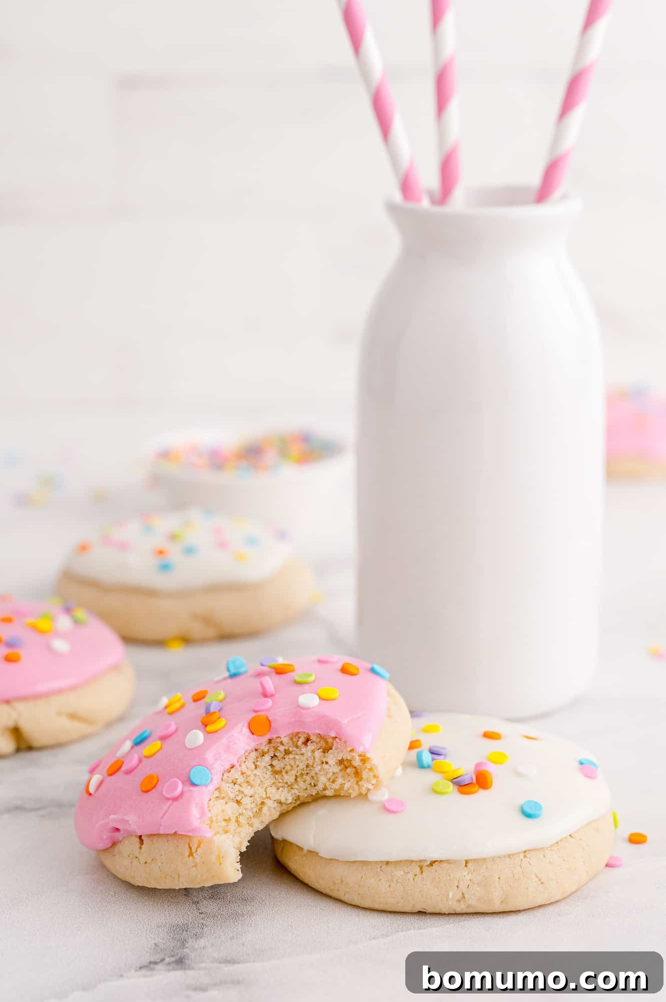 Cookies with milk in background.