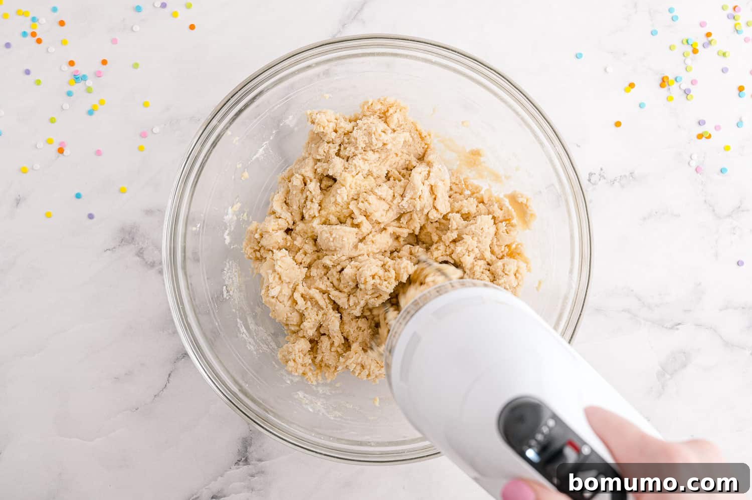 Ingredients being mixed with an electric mixer.